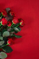 Close-up beautiful red roses bouquet on red background for valen photo