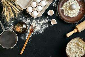 Pasta cooking ingredients on black kitchen table. Top view with space for your text photo