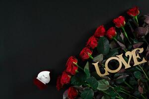 A bouquet of red roses and a box of ring. View top photo
