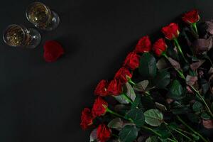 A bouquet of red roses and a box of ring. View top photo