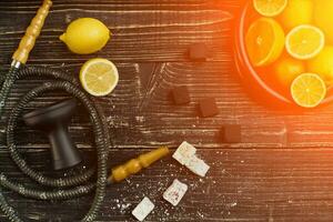 Stylish Smoking hookah and basket with lemon, lime and orange on photo