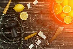 Stylish Smoking hookah and basket with lemon, lime and orange on photo