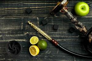 Arabic hookah with a tobacco flavor of a mixture of citruses and apple photo