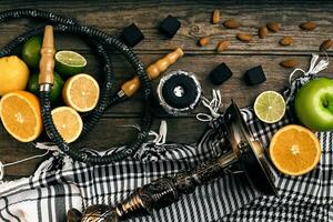 Stylish Smoking hookah and basket with lemon, lime and orange on photo