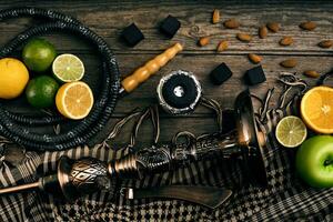 Stylish Smoking hookah and basket with lemon, lime and orange on photo