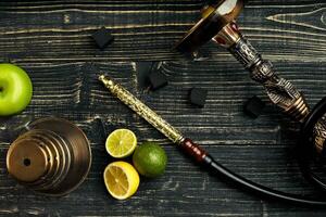 Arabic hookah with a tobacco flavor of a mixture of citruses and apple photo