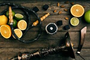 Stylish Smoking hookah and basket with lemon, lime and orange on photo