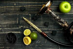 Arabic hookah with a tobacco flavor of a mixture of citruses and apple photo