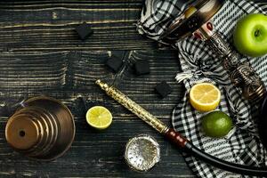 Arabic hookah with a tobacco flavor of a mixture of citruses and apple photo