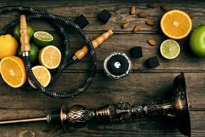 Stylish Smoking hookah and basket with lemon, lime and orange on photo