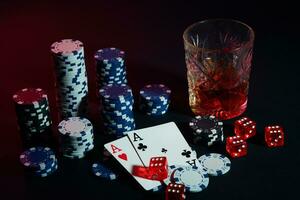 Poker cards with cubes are beautifully placed on the table, against the background of poker chips photo