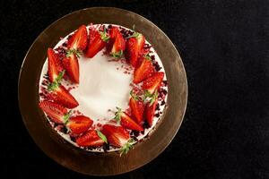 Cheesecake with strawberries. Cake decorated with strawberries. Delicious cheesecake decorated with fresh strawberries. photo