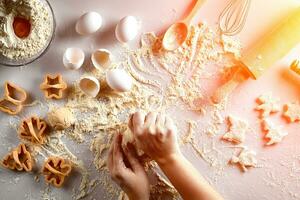 Female hands knead dough with egg and a rolling pin for preparation of cookies. Top view. Sun flare photo