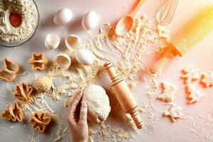 Female hands knead dough with egg and a rolling pin for preparation of cookies. Top view. Sun flare photo