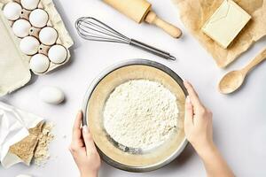 Hand sift flour. Bakery prepare for make cake. Top view photo