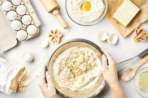 Baker preparing to knead the dough, top view. Cooking, bakery concept photo