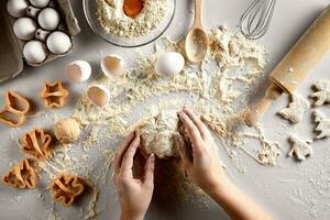 Baking preparation. Raw dough and cutters for the holiday cookies on a white table. Top view. photo