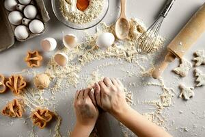 Baking preparation. Raw dough and cutters for the holiday cookies on a white table. Top view. photo