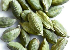 Green cardamom seeds isolated on white background. Top view. Close-up photo