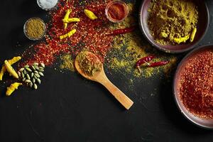 Exotically Spice Mix - spice, herbs, powder top view over dark background. Cooking and spicy food concept. Copy space photo