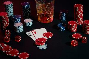 Cards of poker player. On the table are chips and a glass of cocktail with whiskey. Combination of cards photo