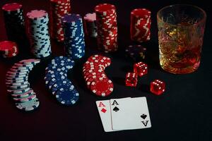 Cards of poker player. On the table are chips and a glass of cocktail with whiskey. Combination of cards photo