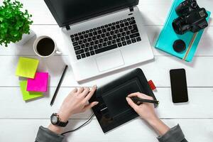 Overhead view of businesswoman working at computer in office photo