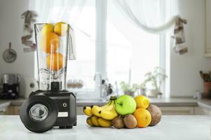 Blender, fruits and kitchen space photo