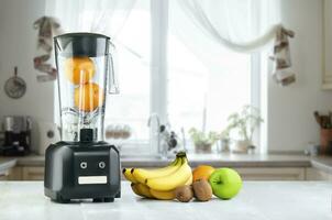 Blender, fruits and kitchen space photo