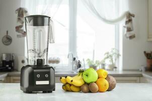Blender, fruits and kitchen space photo