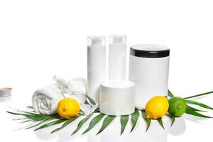 White bottles and two whole lemon and lime isolated on white background. The concept for advertising cosmetics photo