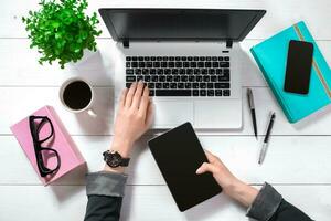 Overhead view of businesswoman working at computer in office photo