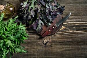 Fresh green arugula on wooden table photo