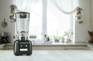 Blender and wooden table in kitchen photo