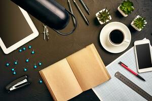 Engineer's desk in office with various gadgets and documents photo