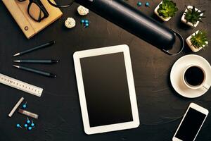 Engineer's desk in office with various gadgets and documents photo