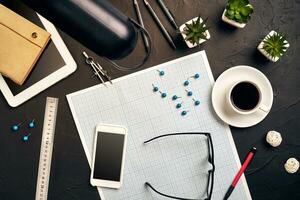 Top view of the builder's workplace, ruler, paper for drawings, compasses, glasses, tablet photo