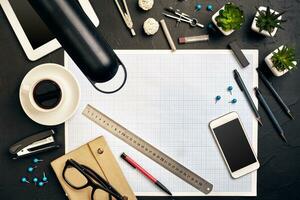 Top view of the builder's workplace, ruler, paper for drawings, compasses, glasses, tablet photo