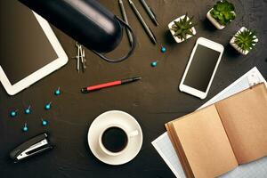 Engineer's desk in office with various gadgets and documents photo