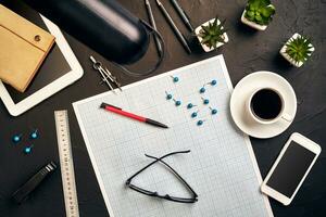 Top view of the builder's workplace, ruler, paper for drawings, compasses, glasses, tablet photo