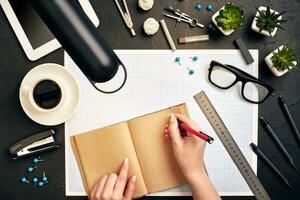 Concept architects. Architects workplace, architectural project, blueprints, ruler. Engineer holds a pen and writes in a notebook. Equipment architects on the desk with a blueprint in the office. photo