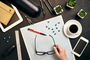 Architect working on blueprint. Architects workplace - architectural project, blueprints, tablet pc. Engineering tools. Top view photo