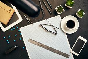 Top view of the builder's workplace, ruler, paper for drawings, compasses, glasses, tablet photo