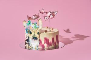 Pastel colors tasty cake with butterflies and little deer. Pink background. Selective focus. photo