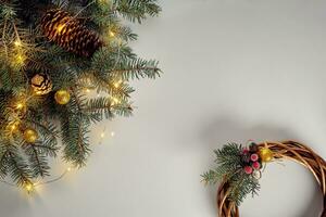 Flat lay of juniper wreath green pine tree branches, wreath and craft paper on white table, top view. photo