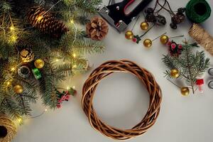 Christmas background with decorations, garland and pine cones. Creating wreath made of christmas tree branches on white background. photo