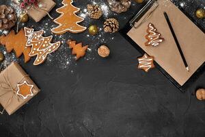 Christmas background with gingerbread cookies and craft sheets of paper. Copy space. photo