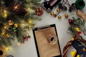 Christmas background with decorations, garland and pine cones. Creating wreath made of christmas tree branches on white background. photo