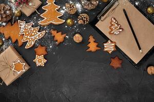 Christmas background with gingerbread cookies and craft sheets of paper. Copy space. photo