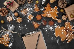 Christmas background with gingerbread cookies and craft sheets of paper. Copy space. photo